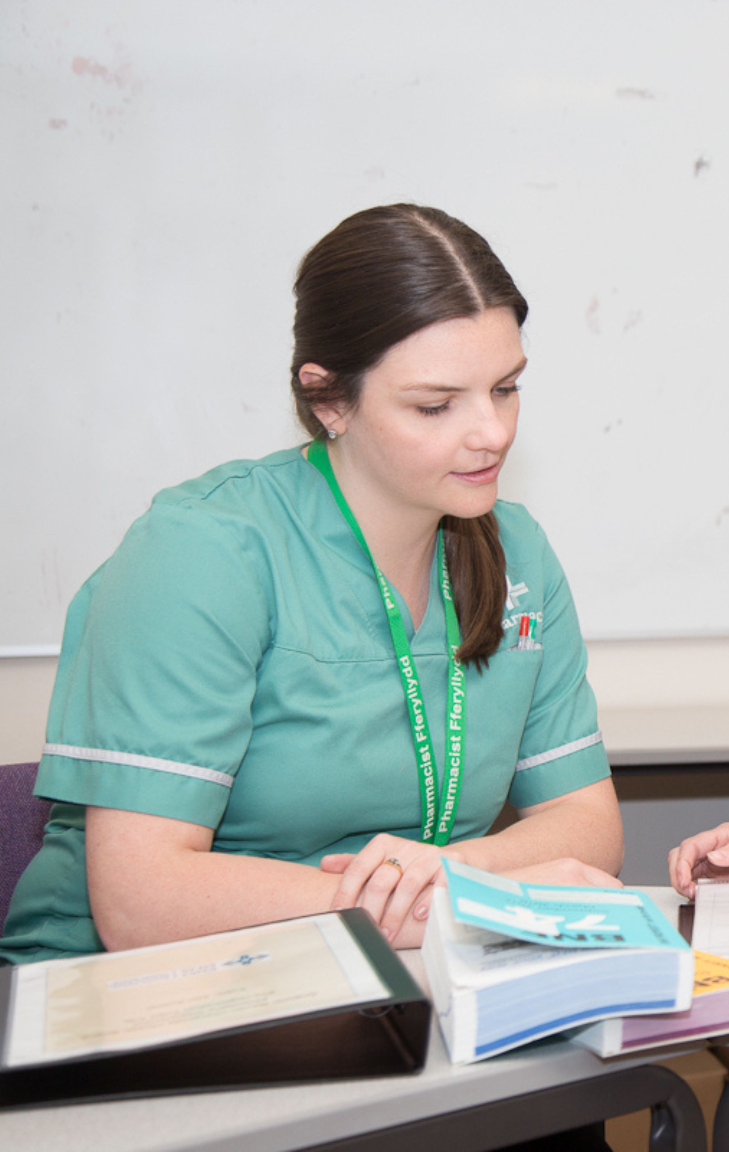 Pharmacy professional reading through notes, training