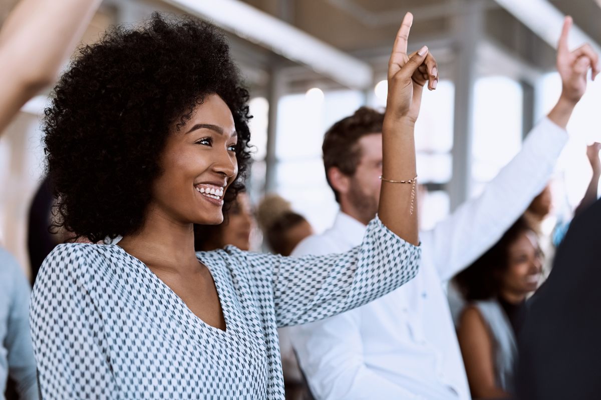 Woman raising hand to answer a question