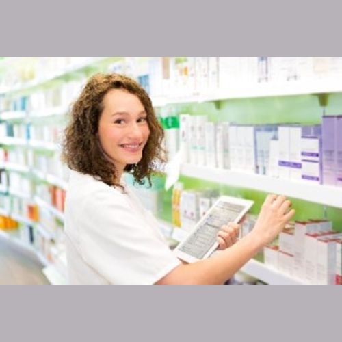 healthcare professional standign next to a shelf filled with medication