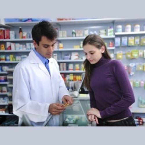 a person at the counter of a pharmacy with a pharmacist behind the counter