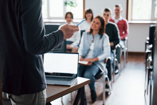 in-person training session tutor at the front and students in a classroom setting