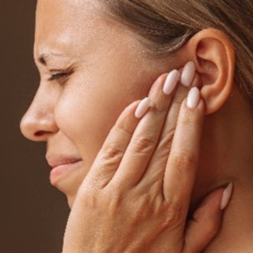 lady hoding her ear in pain.