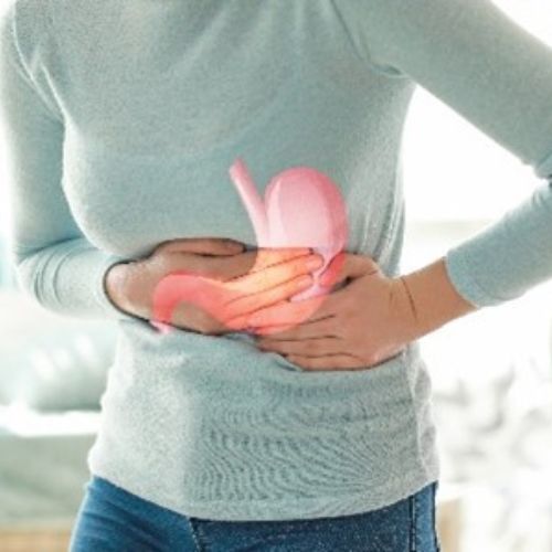 Lady clutching her stomach with a graphic of the organ stomach on her body