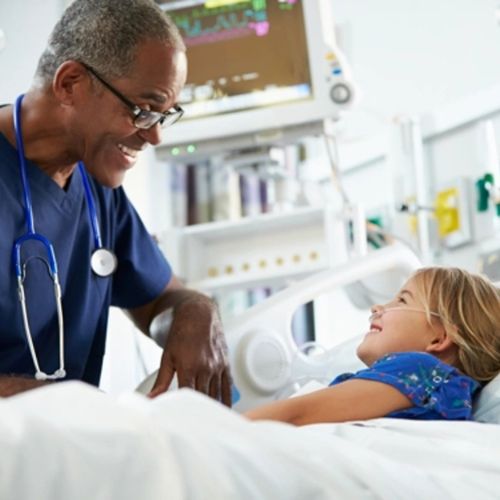 a healthcare professional at the hospital beadside of a child