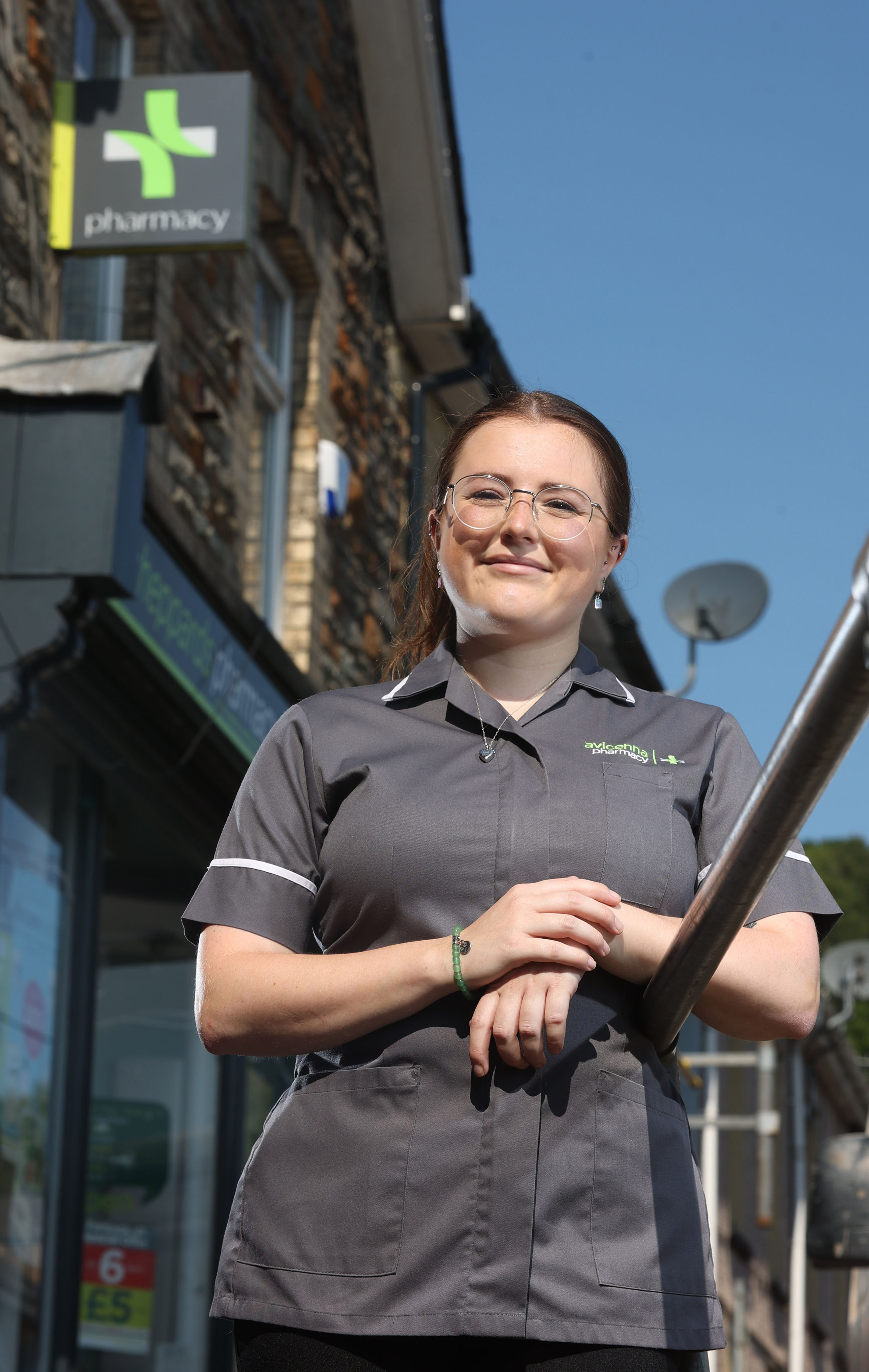 pharmacy professional standing outside a pharmacy