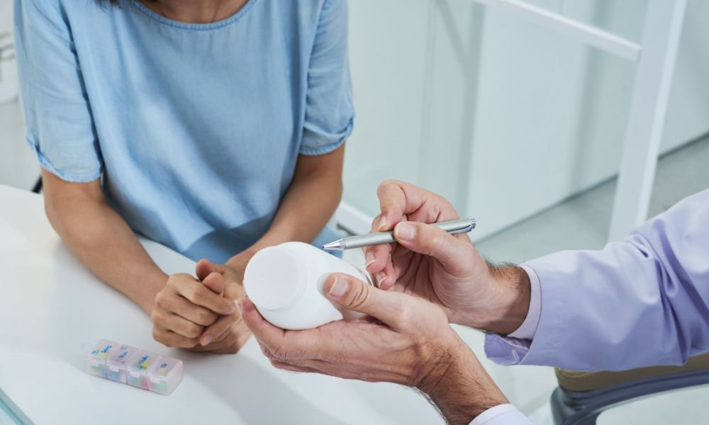 healthcare professional showing a medicine to a patient in clinic