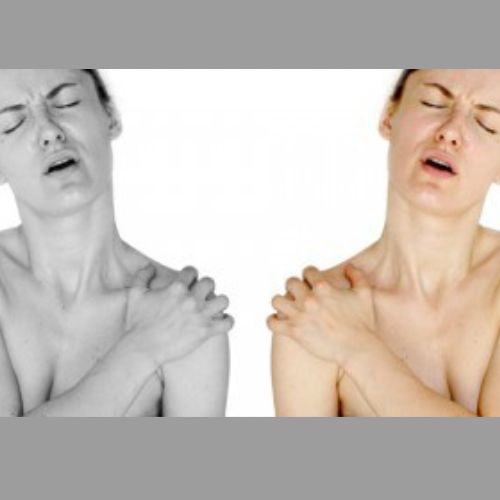 lady hoding her shoulder in pain.