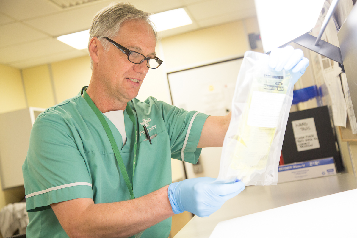A healthcare professional examining a patient sample