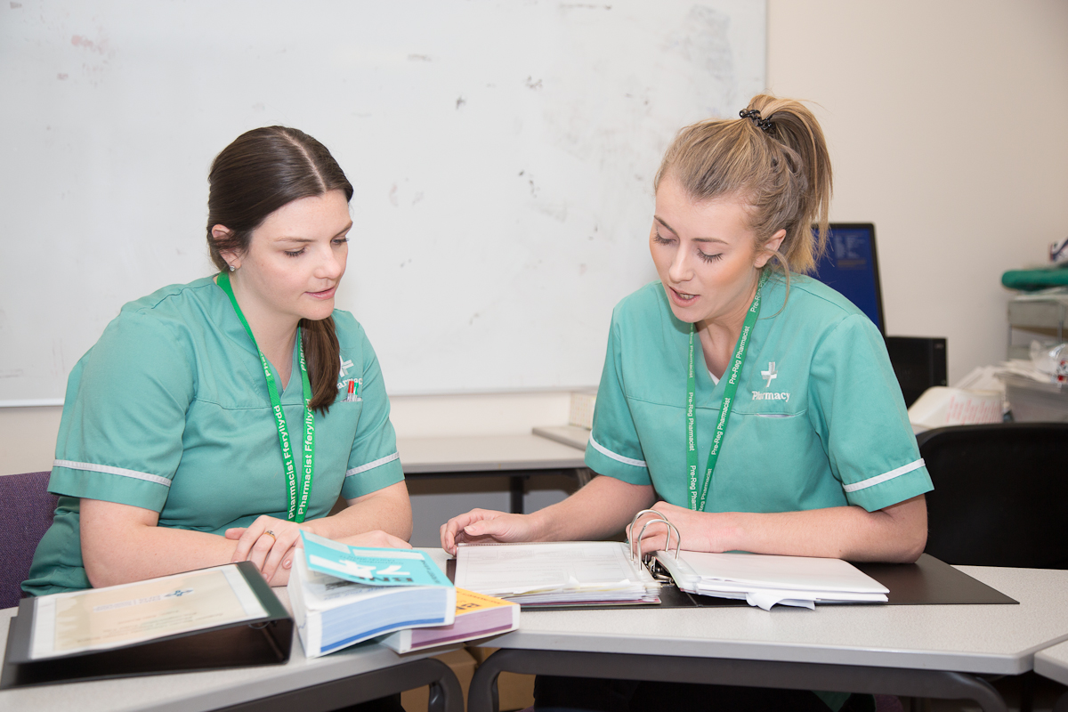 two healthcare professionals at a desk