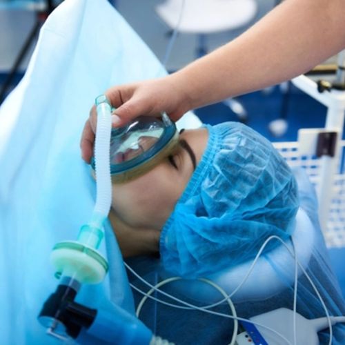 Patient on a medical bed with an oxygen mask
