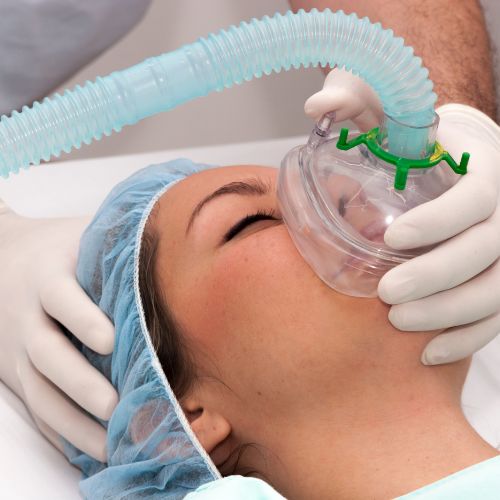 Patient on a medical bed with an oxygen mask