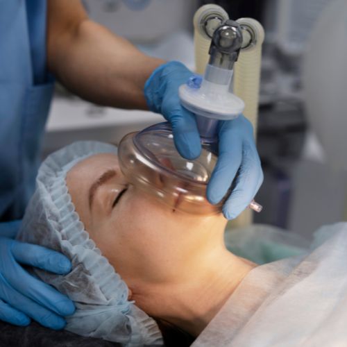 Patient on a medical bed with an oxygen mask