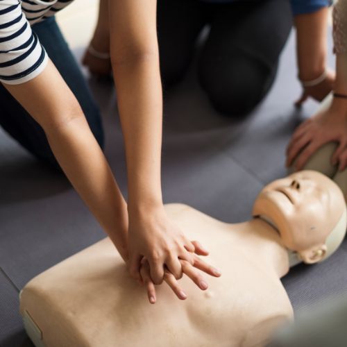 CPR being practiced on a CPR manikin