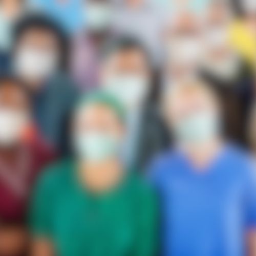 blurred image of Healthcare workers wearing face masks