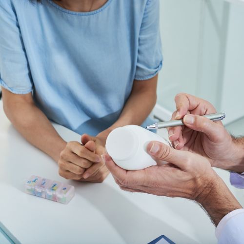 healthcare professional showing a medicine to a patient in clinic