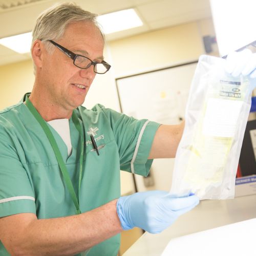 healthcare professional at a desk looking at paperwork