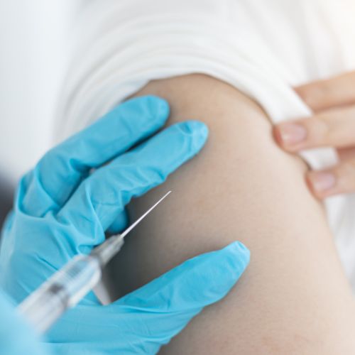 Person getting a flu vaccination on their arm