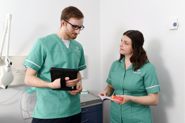 two health care professionals in a clinical setting