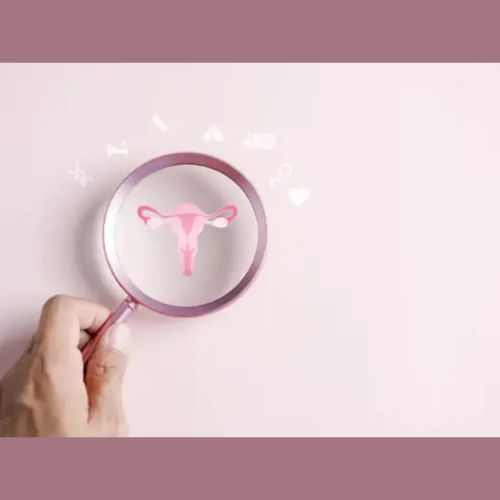 Hand holding a magnifying glass over a uterus symbol with health icons on a pink background.