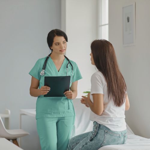 Patient in consultation with a healthcare professional at bedside