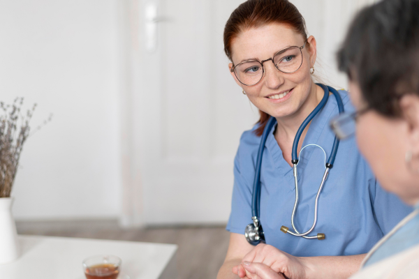 female doctor looking at a patient with a smile